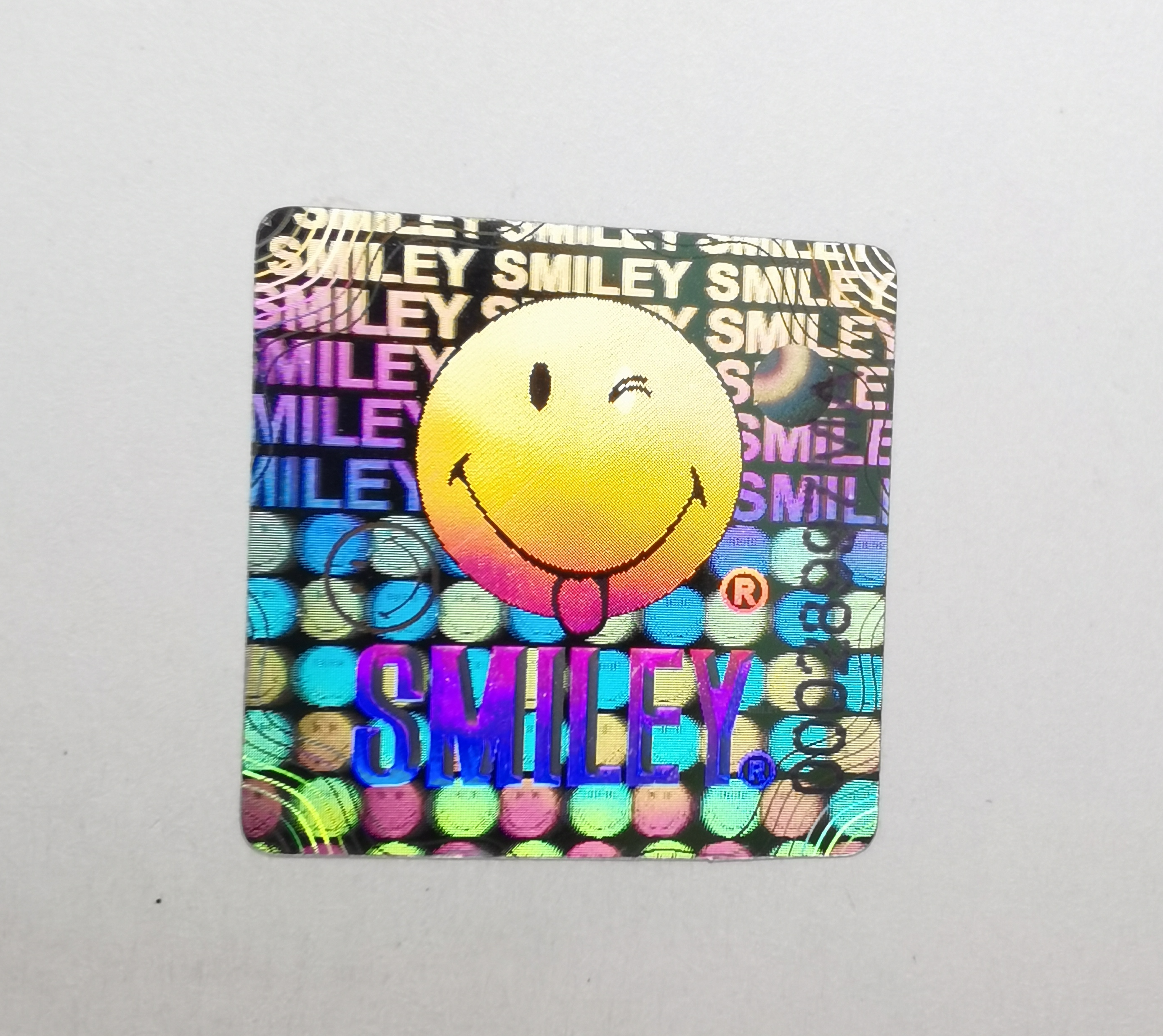 Smiley face holographic sticker serial number
