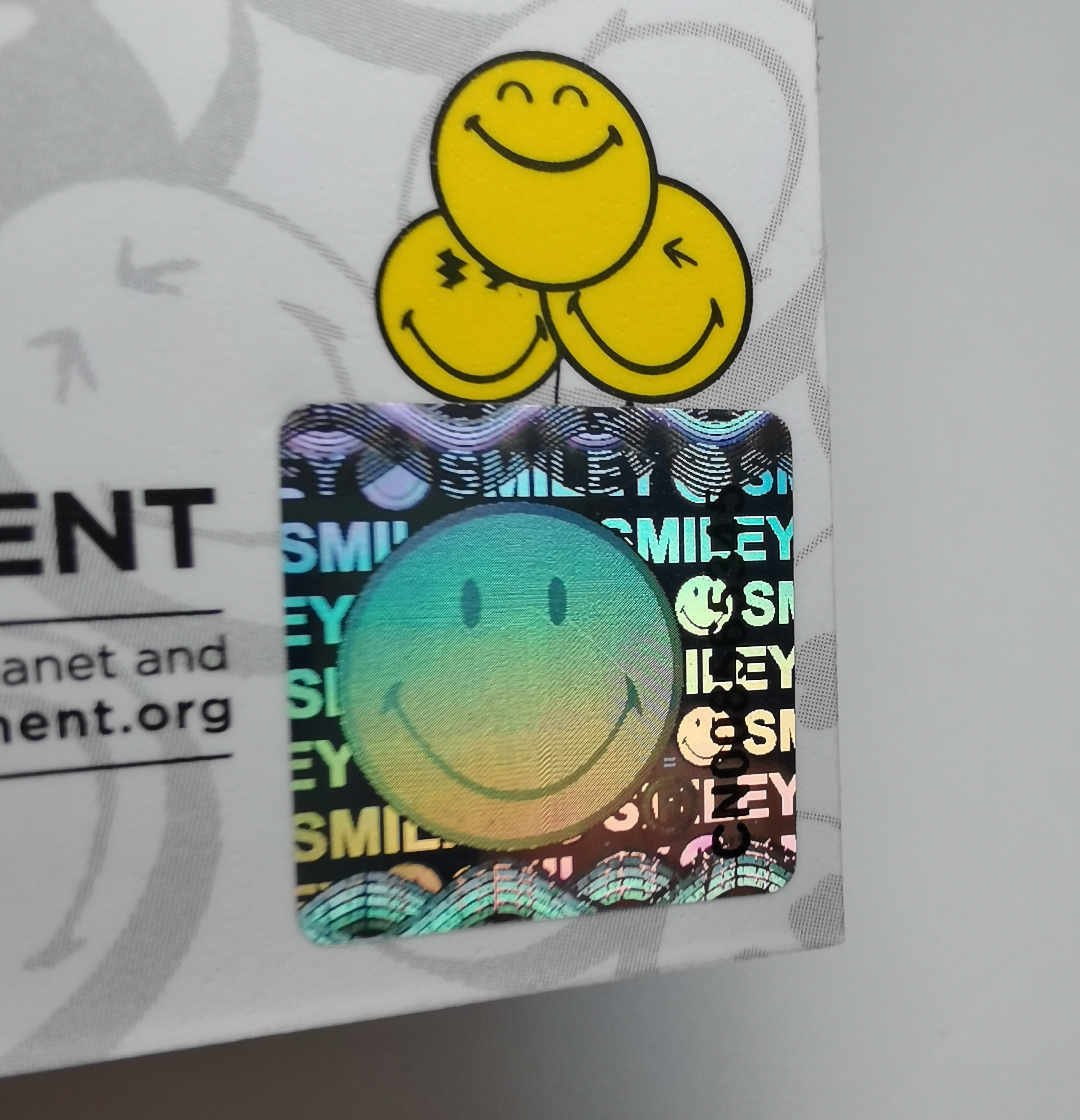 Smiley ansikte holografisk klistermärke serienummer