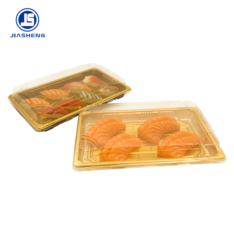 Gold-base sushi trays with clear domed lids packed with salmon nigiri