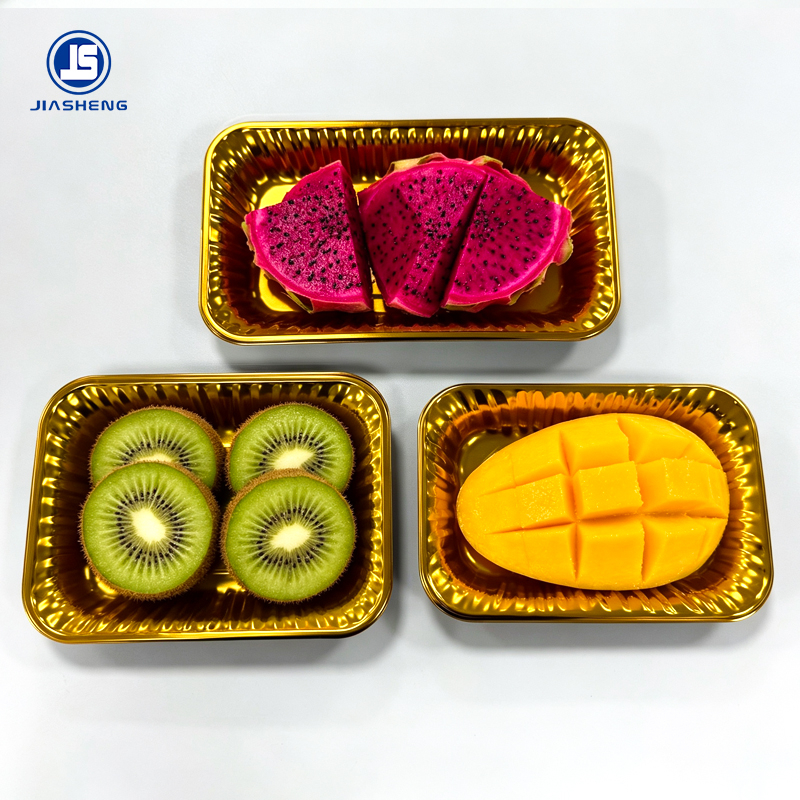 Golden PET fruit trays presenting dragon fruit kiwi and mango for premium retail display