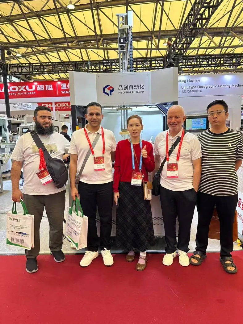 Group photo with visitors in front of the Pinchuang booth at All in Print China 2026
