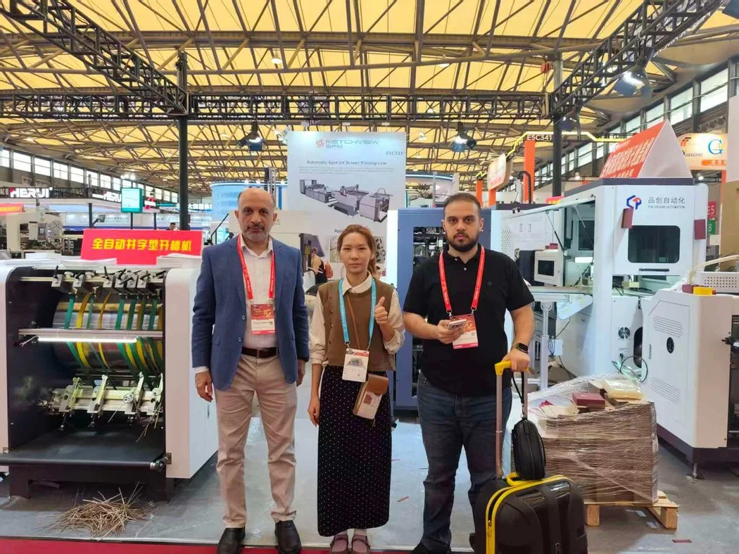 Visitors with Pinchuang staff beside rigid box machinery at All in Print China 2026