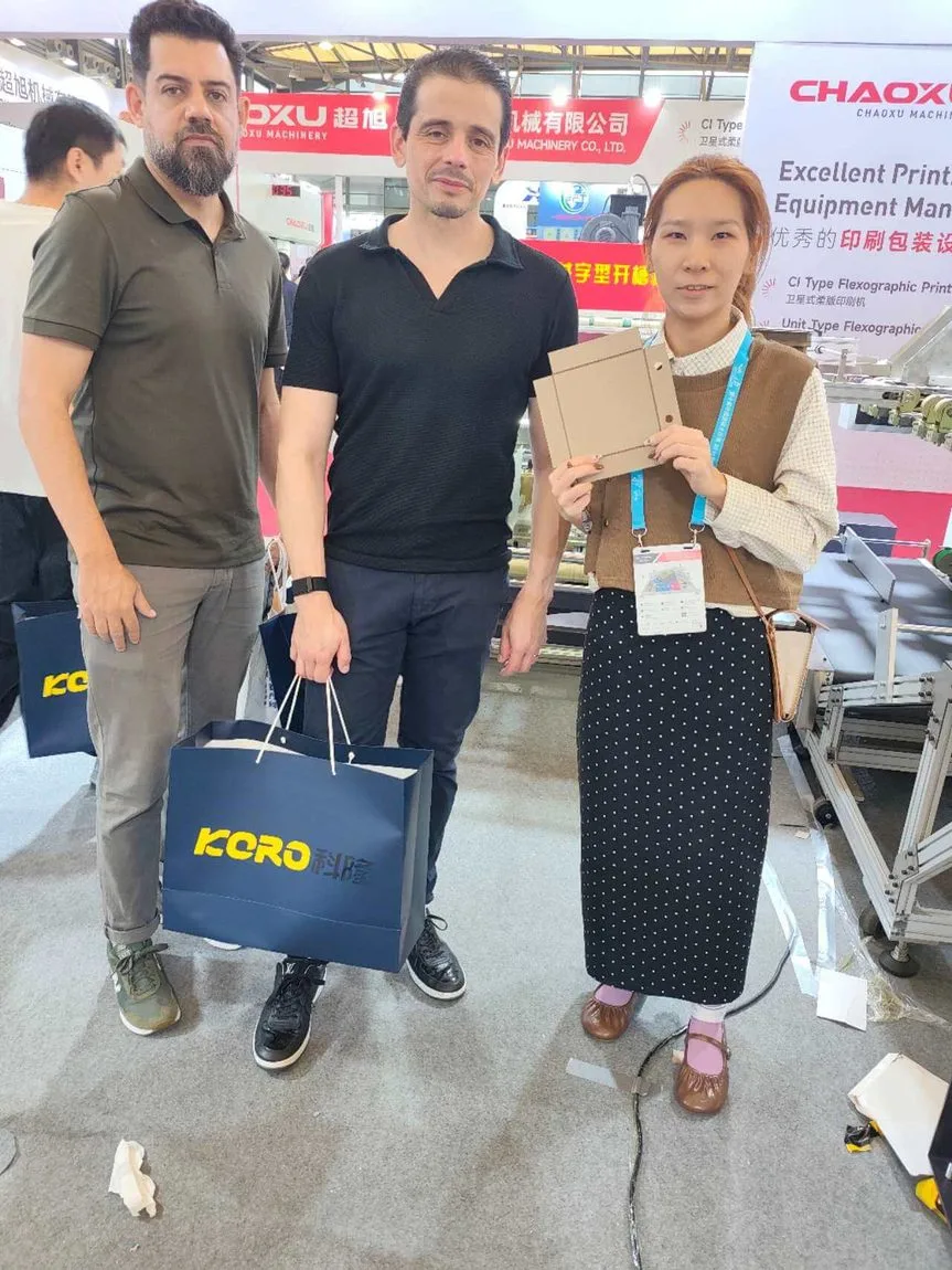 Pinchuang staff reviewing a rigid box sample with overseas visitors