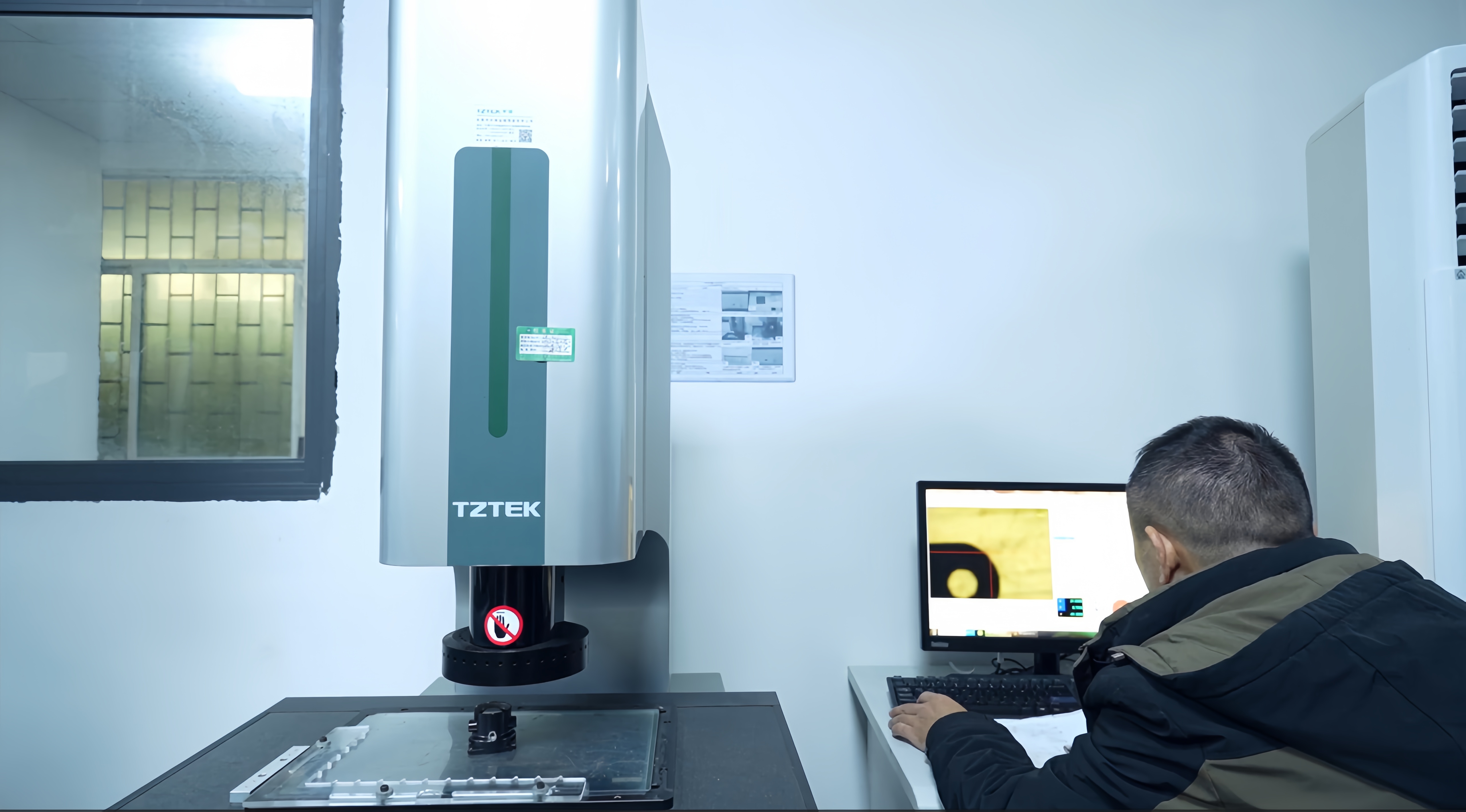 Engineer reviewing CNC machined precision metal parts in manufacturing facility