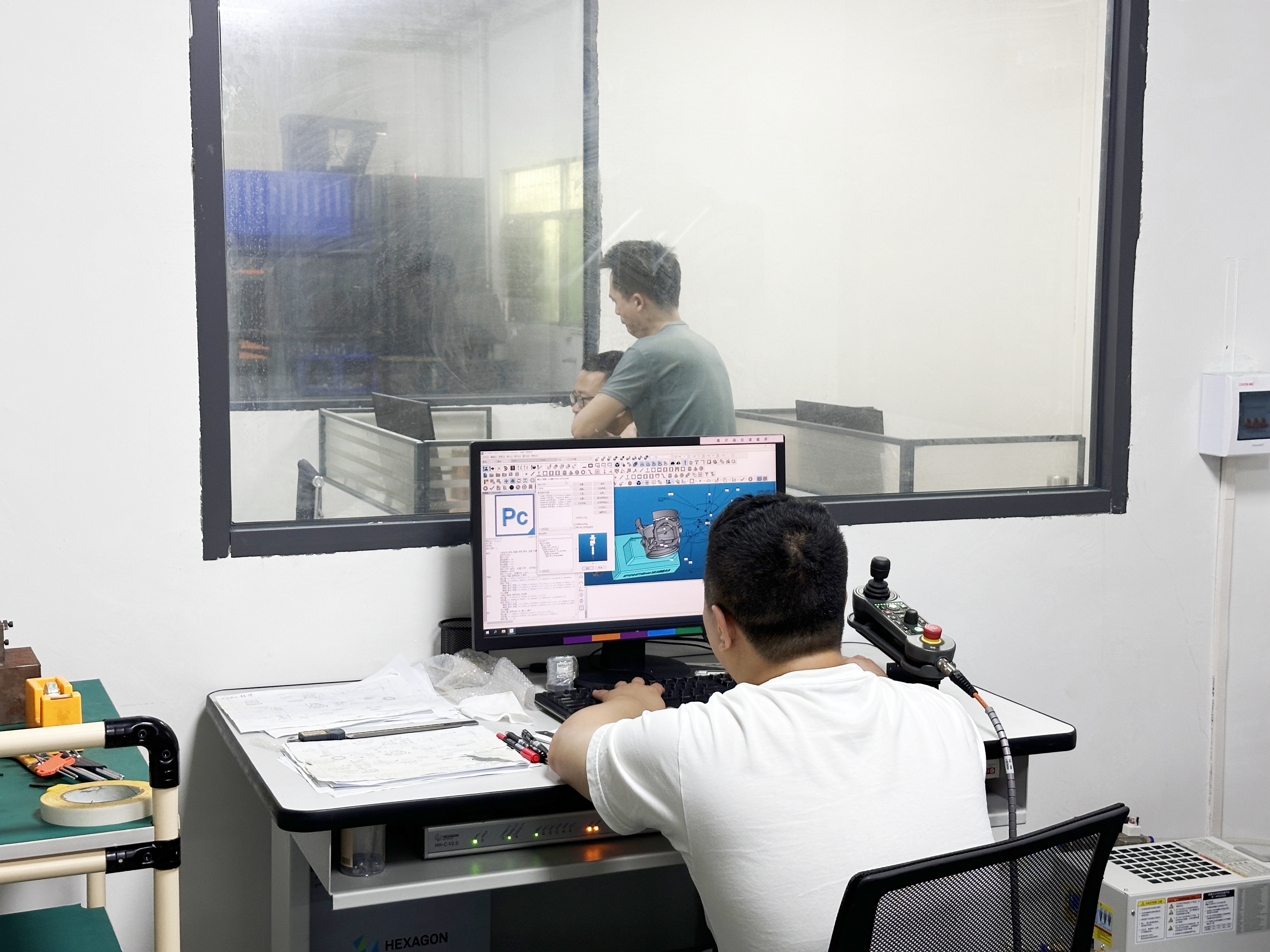 Engineering team reviewing precision metal parts at SUNPREC
