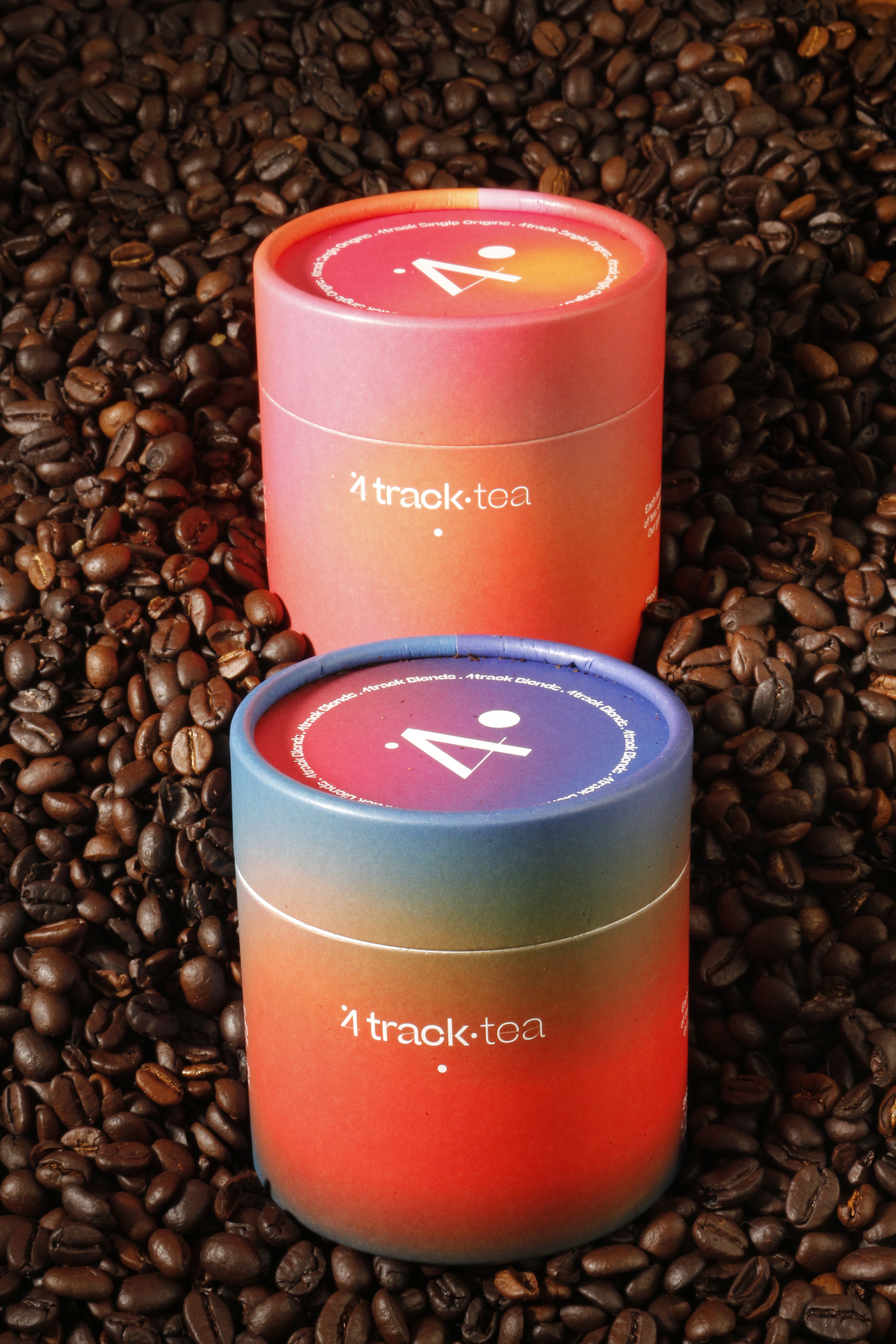 Custom paper tube packaging for coffee with colorful gradient design on coffee beans