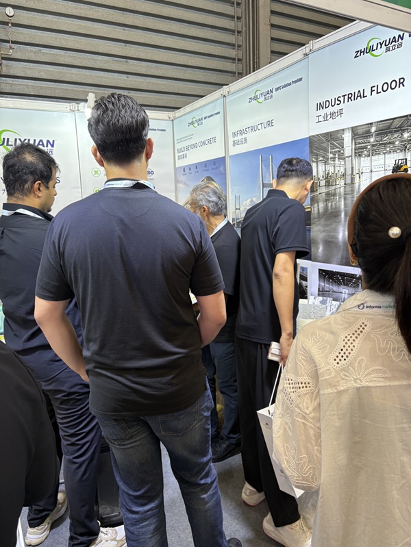 Visitors exploring ZHULIYUAN industrial flooring and UHPC building envelope systems at WOCA