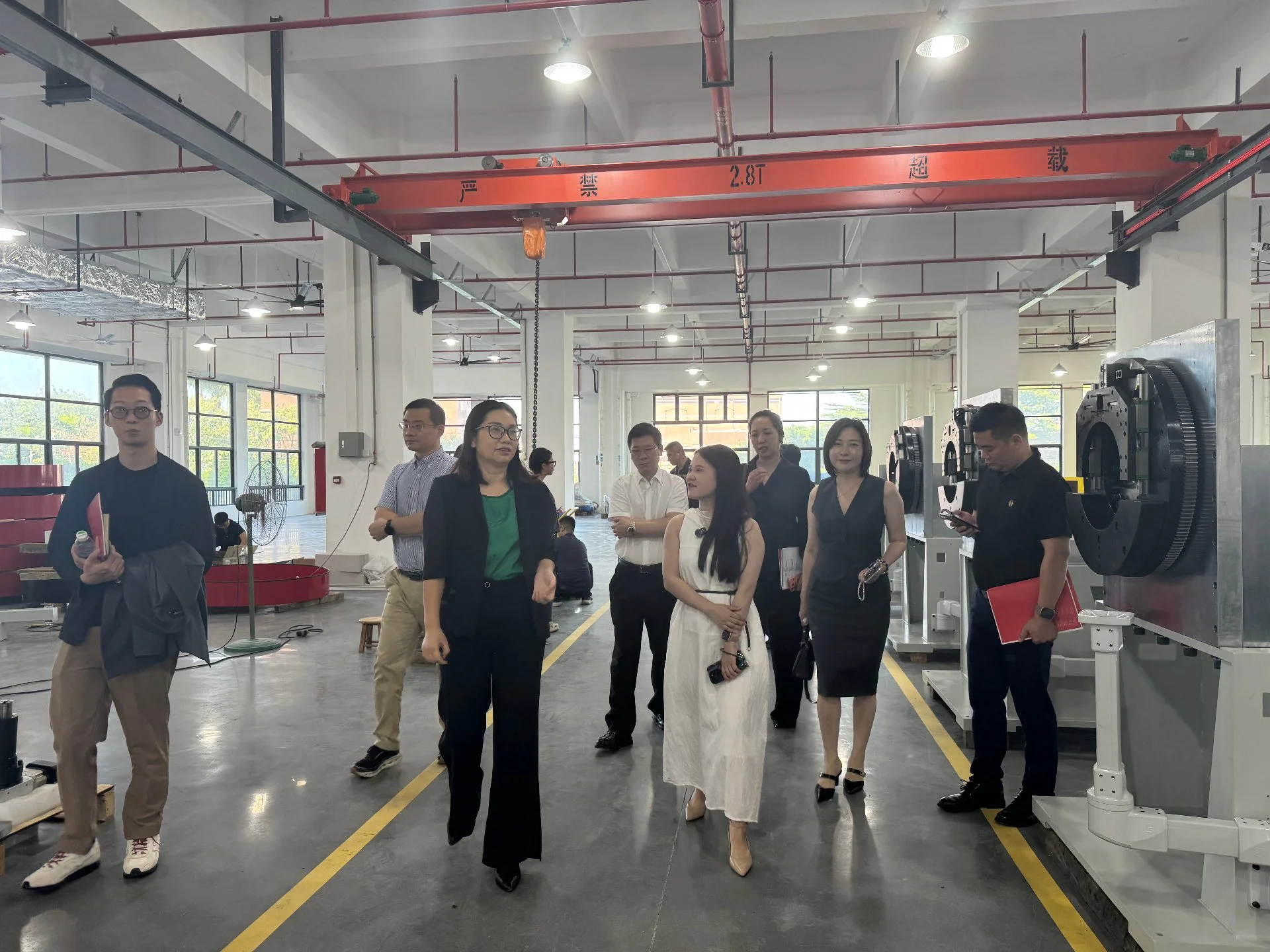 Delegation walking through the BELAN assembly workshop during the factory tour