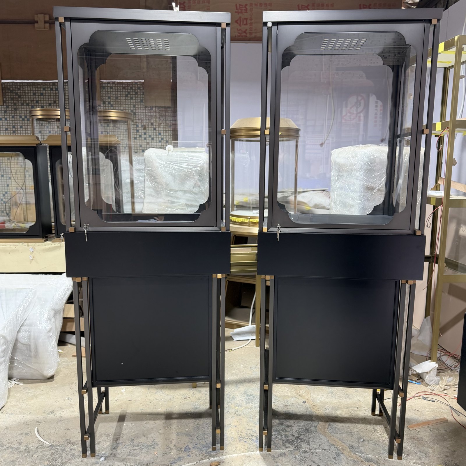 Close-up of glass panels and metal frame corners on jewelry display vitrines