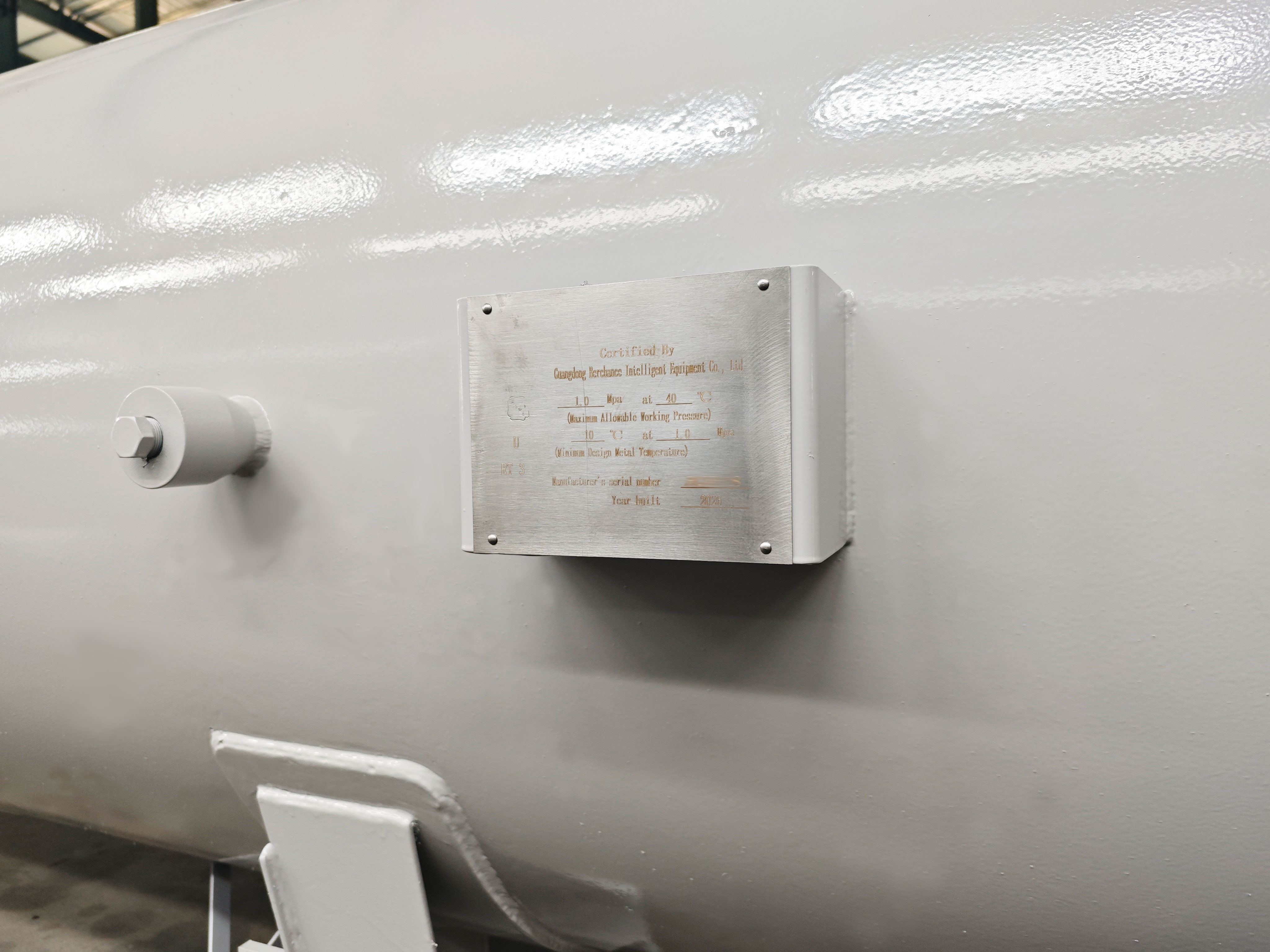 ASME U Stamp identification plate on carbon steel pressure vessel