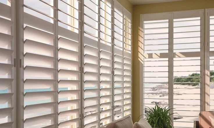 white wood shutters with view of the beach